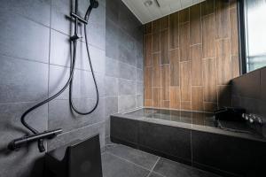 a bathroom with a shower with a tub and a sink at SANA伊豆大室山 -Pool Villa- in Ito +31 photos