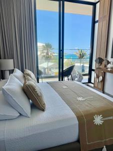 a bedroom with a bed with a view of the ocean at Luxury new apartment with balcony close to beaches in San Andrés