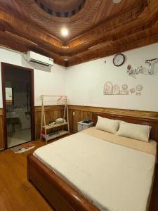 a bedroom with a bed and a clock on the wall at An Nam HomeStay1 in Thôn Trường Giang +17 photos