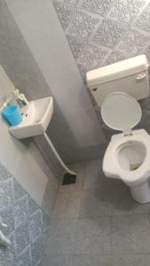 a bathroom with a toilet and a sink at DWARKA HOME STAY AC rooms Hall For family only in Dwarka