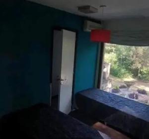 a room with a door and a window and a room with a bed at Casa quinta con jardín y pileta in Luján +6 photos