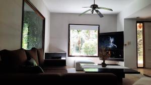 a living room with a couch and a large window at Casa quinta con jardín y pileta in Luján