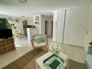 a living room with a couch and a table at Cambo T2 rénové, 2 couchages, balcon, Wi-Fi - FR-1-495-155 in Cambo-les-Bains
