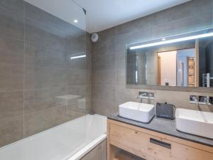 a bathroom with a tub and a sink and a bath tubermottermott at Appartement moderne, Alpe d'Huez, 6 pers, cosy et pratique - FR-1-645-87 in L'Alpe-d'Huez +6 photos