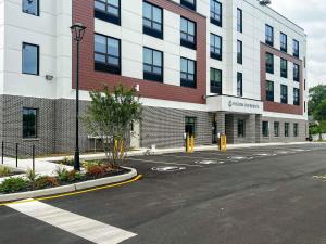 an empty street in front of a large building at 403 Modern Brand New Studio Apartment in East Spotswood +6 photos