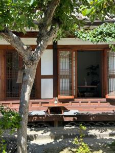 a building with a table and a tree at Hanok Got in Seoul