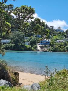 a view of a river with houses in the background at Walk to the beach in Taipa