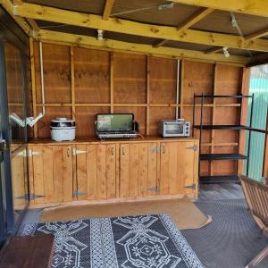 a room with a laptop on a wooden cabinet at Walk to the beach in Taipa +9 photos
