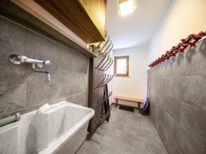 a bathroom with a bath tub and a sink at Chalet in Neukirchen near Ski Area in Rosenthal +45 photos