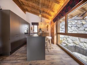a kitchen with a counter and a large window at Chalet in Neukirchen near Ski Area in Rosenthal