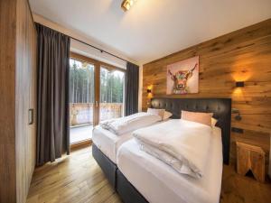 a bedroom with two beds and a large window at Chalet in Neukirchen near Ski Area in Rosenthal