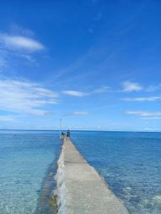 a pier in the middle of a large body of water at Evashore Beach Resort in Limasawa Island +2 photos