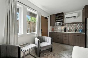 a living room with a chair and a table at Adelynn Studio Walkable Kerns Spanish Charm in Portland