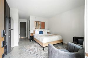 a bedroom with a bed and two chairs at Adelynn Studio Walkable Kerns Spanish Charm in Portland