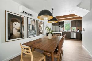 a kitchen and dining room with a wooden table and chairs at The Adelynn - Luxury 2BR Home in Walkable Portland in Portland