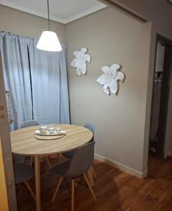a dining room table with chairs and a table and a light at Neptuno VI in Mar del Plata