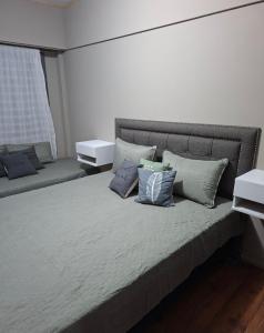 a bedroom with a bed with pillows on it at Neptuno VI in Mar del Plata