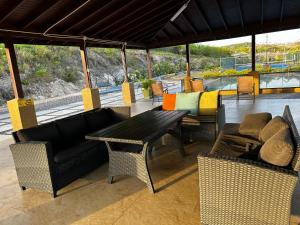 a patio with a table and chairs and a couch at Jepel's Escape in Florence Hall