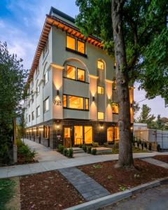a large building with a tree in front of it at Spacious 6BR - New Spanish Home in Best Kerns Spot in Portland