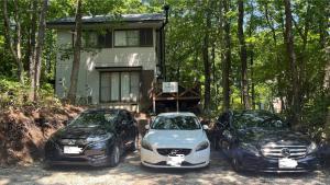 a couple of cars parked in front of a house at Villa Foresta TERU in Nasu +80 photos