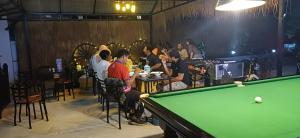 a group of people sitting around a pool table at Angkor Gecko's Inn Hotel & Guesthouse in Siem Reap +25 photos