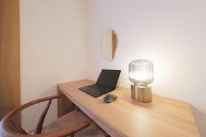 a desk with a laptop and a lamp on it at Cozy Nest Sangenjaya 1 Stop to Shibuya ーWalk to Sangenjaya and Ikejiri in Tokyo