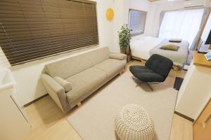 a living room with a couch and a bed at Cozy Nest Sangenjaya 1 Stop to Shibuya ーWalk to Sangenjaya and Ikejiri in Tokyo
