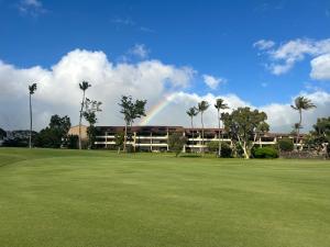 a rainbow in front of a building with a green field at F 101 Kaanapali Royal Resort Ground Floor Upgraded Condo in Kaanapali