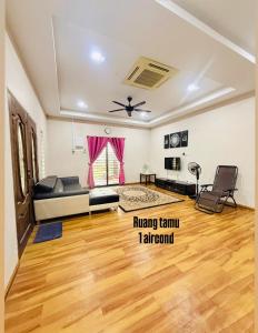 a living room with a couch and a table at IMAN Homestay in Melaka