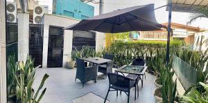 a patio with a table and chairs and an umbrella at Hotel Pier Cuatro in Cebu City