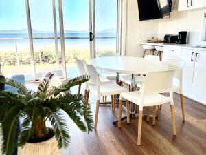 a kitchen and dining room with a table and chairs at BIG4 Wilsons Prom Holiday Park in Yanakie