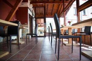 a restaurant with chairs and tables in a room at Hotel Mariñerune in Mungia