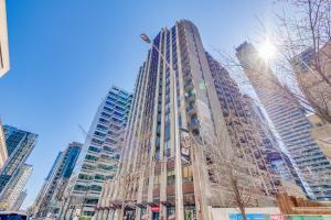 a tall building in the middle of a city at 2BR Yorkville Condo - Self Check In & Free Parking in Toronto