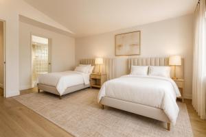 two beds in a white room with two lamps at Venice Sunny 2BR Haven - 7-min Walk to Venice Beach in Los Angeles +12 photos