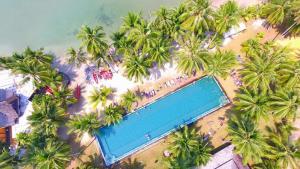 an overhead view of a swimming pool on a beach with palm trees at Blue Haven Bay Villas and Resort Apartments in Ko Chang