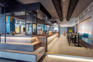 a restaurant with a counter and a bar at Pharos Hvar Bayhill Hotel in Hvar