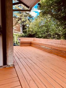 a porch with a wooden deck with trees at Tamira Villa in Winnipeg +45 photos