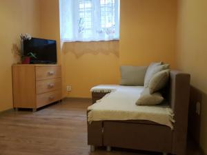 a bedroom with a bed and a tv and a dresser at Pokoje Gościnne Centrum in Krakow
