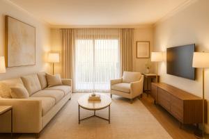 a living room with a couch and a tv at Venice Boardwalk Breeze 2BR - 7-min to Venice Beach in Los Angeles