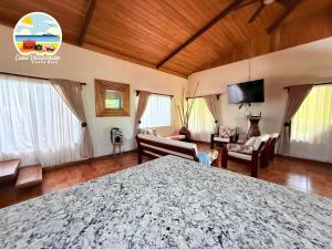 a bedroom with a large bed and a living room at Casa Toscana in Santa Cruz