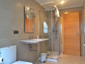 a bathroom with a sink and a shower and a toilet at Apartamentos Albatros in Barro de Llanes