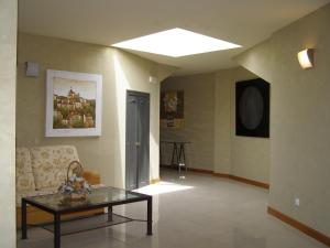 Hotel Area Serrano في Buniel: غرفة معيشة مع أريكة وطاولة