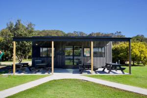 a pavilion with picnic tables and benches in a park at BIG4 Wilsons Prom Holiday Park in Yanakie