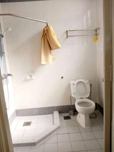 a bathroom with a toilet and a shower with a towel at Costa Mahkota Two Bedroom With Balcony , Mahkota Hospital , Parade , Pahlawan in Melaka