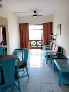 a living room with chairs and tables and a couch at Costa Mahkota Two Bedroom With Balcony , Mahkota Hospital , Parade , Pahlawan in Melaka