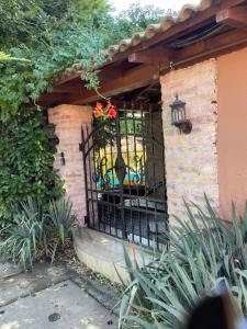a black iron gate with a flower pot on it at Hacienda Apartman in Békéscsaba