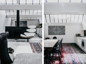 a kitchen and a living room with a table and chairs at Alkina Lodge Yulu in Wattle Hill