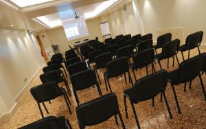 an empty room with chairs and a podium at The Ziba Hotel & Spa in Peschiera del Garda +37 photos
