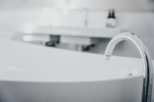 a white kitchen sink with a faucet at Alkina Lodge Yulu in Wattle Hill +28 photos