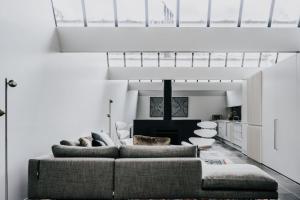 a living room with a couch and some chairs at Alkina Lodge Yulu in Wattle Hill